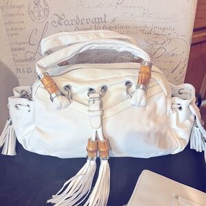 Brand new BeBe white handbag with matching wallet.